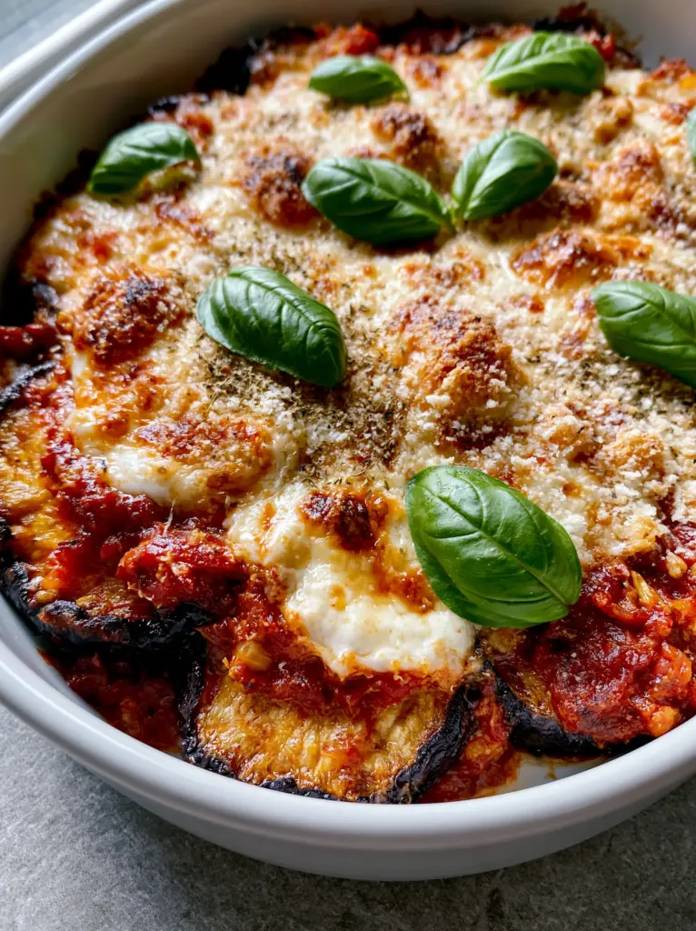Close-up of the crispy parmesan crust and bubbly mozzarella on top of an eggplant casserole.