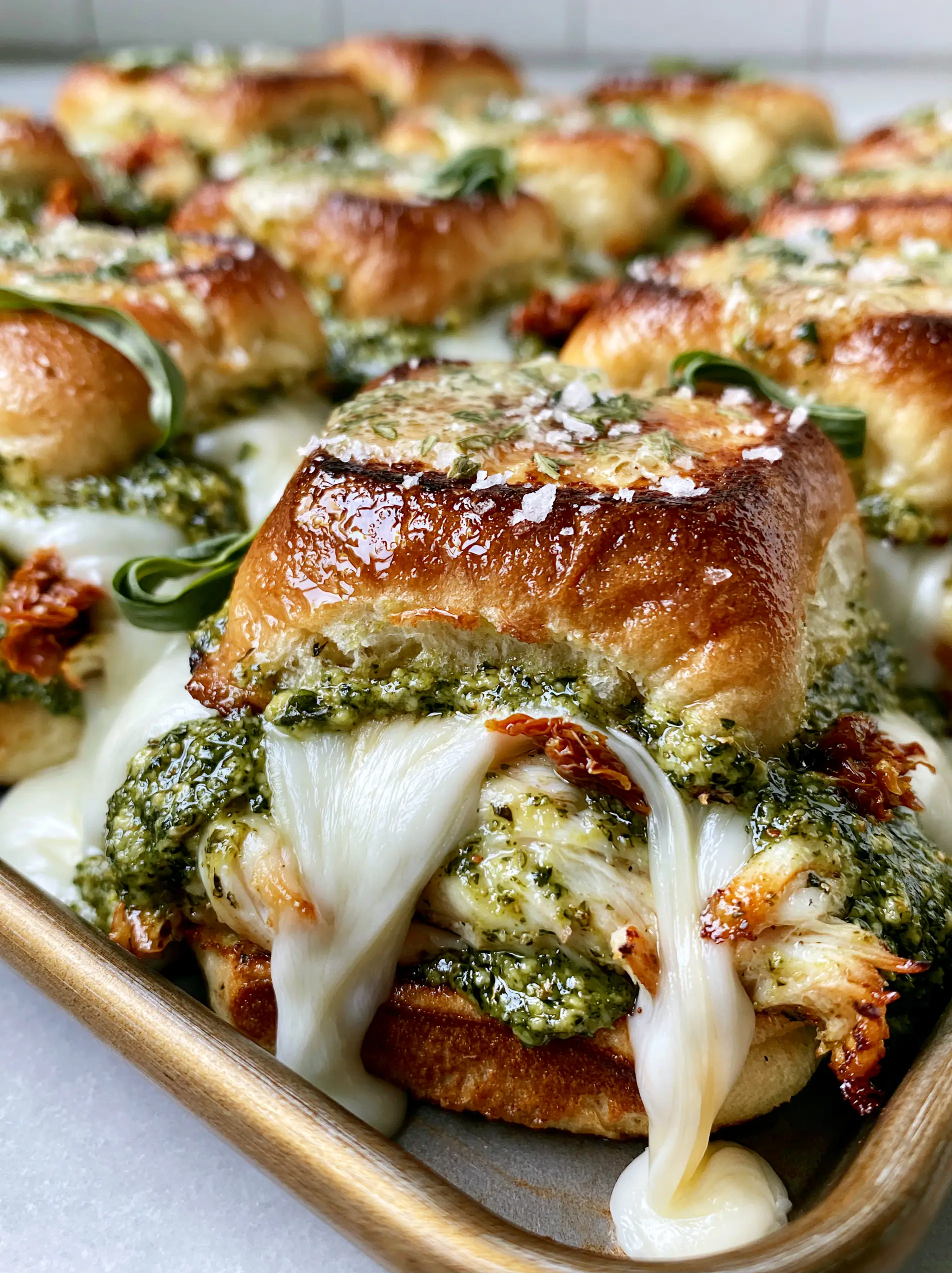 Close up of glossy brioche buns with melted mozzarella cheese pulling apart. (Back to School Dinner Ideas)